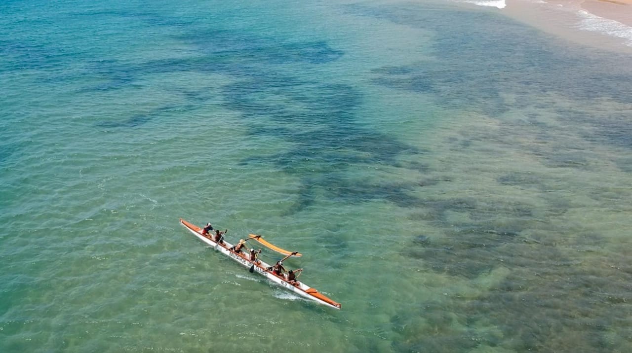 Vista aérea da canoa remando perto da praia